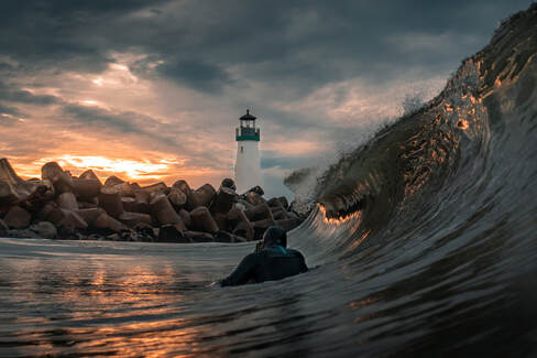 Photographer John Fox shooting a lighthouse from the water at sunset.